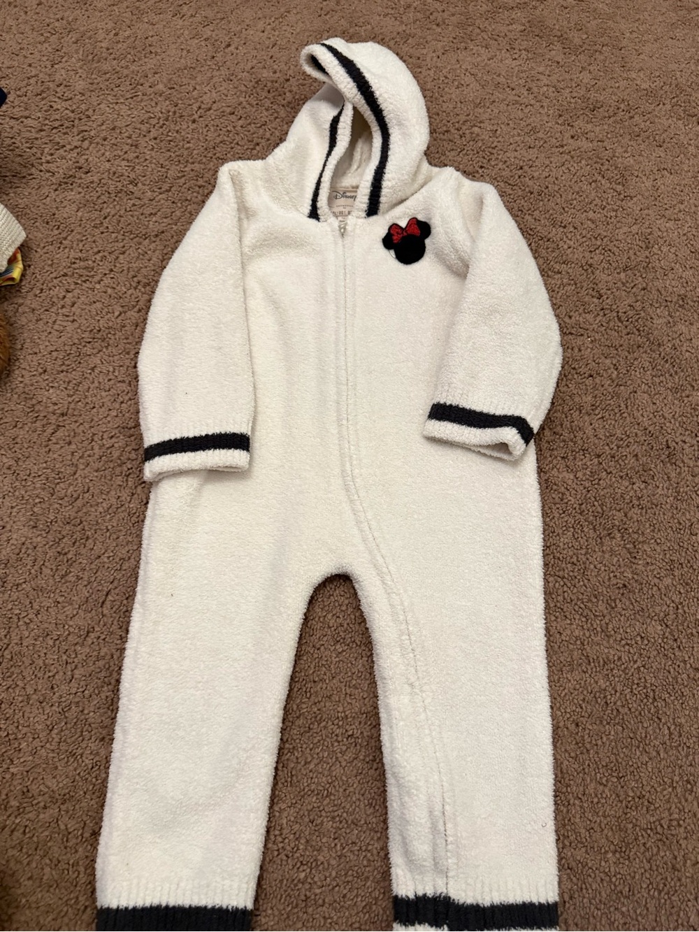Barefoot Dreams Cream Hooded One-Piece with Black Trim and Red Bow Patch